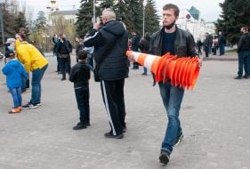A man carries road cones