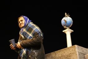 Elderly woman asking for alms