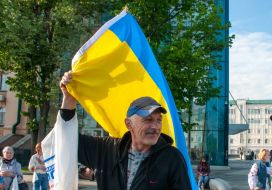 Participant of the march, holding the flag of Ukraine