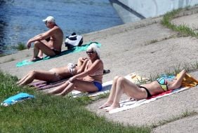 People relax on the beach