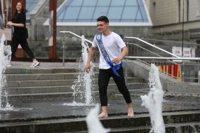 The graduate bathes in a fountain