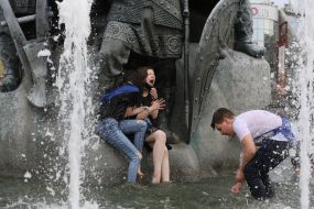 Graduates bathe in a fountain