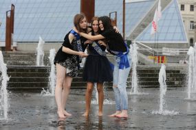 Graduates bathe in a fountain