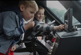 Boys in the cabin of a military armored car