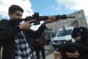 The boy examines the machine gun