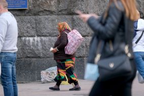 Woman with a cup for alms
