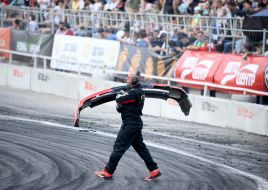Man carries the bumper of a car