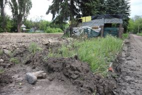Military boot on the ground on the background of the dugout