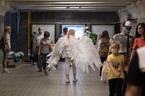 Woman in the costume of an angel in the underpass in Kiev