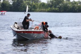 Rescue divers remind vacationers about the rules of conduct near the water on the beach in Kiev