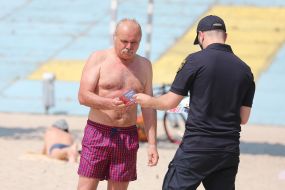 Rescue divers remind vacationers about the rules of conduct near the water on the beach in Kiev