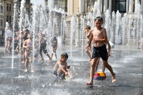 Дети играют в фонтане