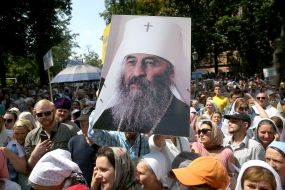 Believers hold a portrait of Metropolitan Onufriy