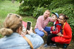 The boy is photographed with artists
