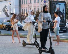 Women in hijabs on electric scooters