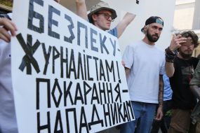 Protesters hold posters