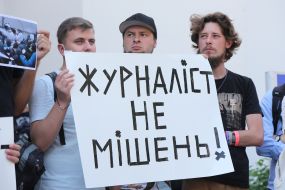 Protesters hold posters