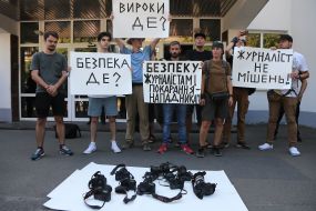Protesters hold posters