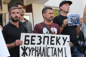 Protesters hold posters