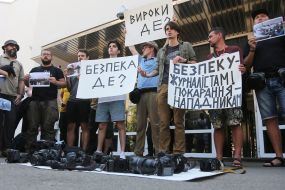 Protesters hold posters