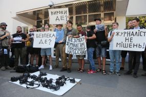 Protesters hold posters