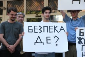 Protesters hold posters