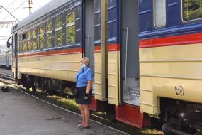 Conductor-cashier near the electric train