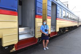 Conductor-cashier near the electric train