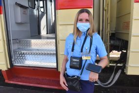 Conductor-cashier near the electric train