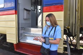 Conductor-cashier near the electric train