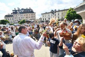 The priest consecrates the fruit baskets