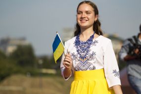 Girl in an embroidered shirt with the flag of Ukraine