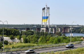The giant flag of Ukraine on the pylon of the new Zaporizhia bridge