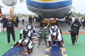 Strongmen near the AN 225 "Mriya"