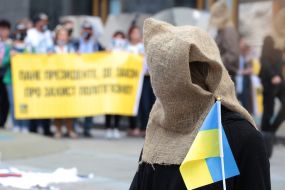 Participant of the action-performance with a bag on his head