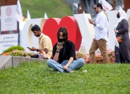 The girl is resting on the lawn on Independence Square
