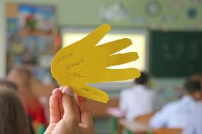 The student holds a palm with wishes