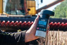 The agronomist holds a moisture meter