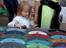 Girl examines beads