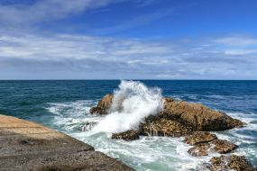 Coastal rocks near the lighthouse Felgeiras on the Atlantic coast in Porto