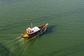 Excursion boat sails on the Douro River in Porto