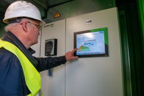 Engineer operates a containerized gas piston power plant