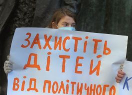 The participant of the action holds a poster