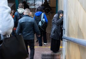 An elderly woman in an underground passage