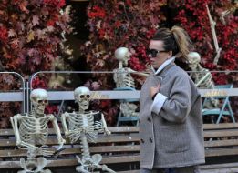A woman walks near the skeletons