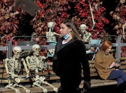 A woman walks near the skeletons