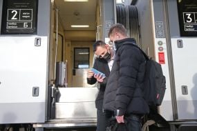 The passenger presents the Covid vaccination certificate to the conductor