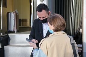 The passenger presents the Covid vaccination certificate to the conductor