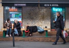 Пьяный мужчина лежит на скамейке у столиков одного из кафе