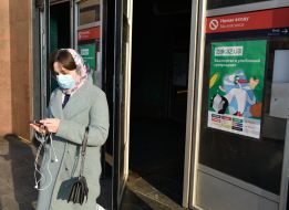 Woman in a medical mask at the entrance to one of the metro stations in Kiev